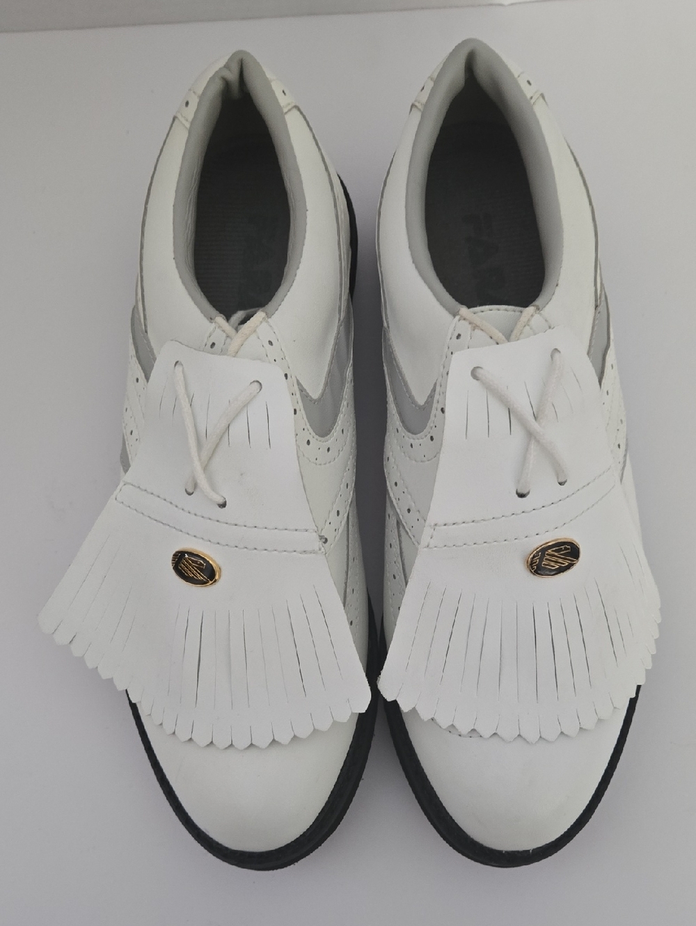 White Fringe Kiltie Golf Sneaker with Gold Oval Accent